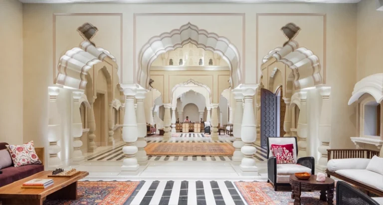 Luxury heritage palace hotel lobby with carved arches and marble flooring