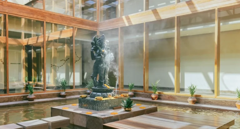 Tranquil wellness resort indoor courtyard with reflecting pool and stone statue